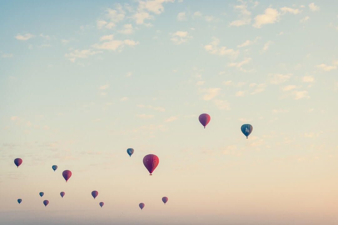 flying hot air balloons at daytime